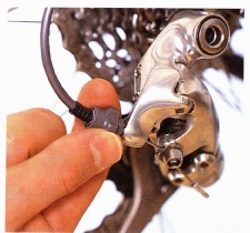 Shift back to the smallest cog, then shift upward through each gear. If the rear derailleur does not shift all the way onto the next-biggest cog, screw out the barrel adjuster until it does. If the derailleur overshifts and skips a cog, screw in the barrel adjuster until it stops. 