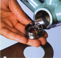 Remove the fixed cup on the drive side of the bike by using a fixed-cup spanner on its two flats and turning clockwise.