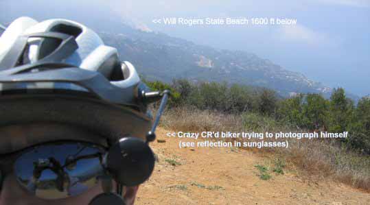 biker at Parker Mesa Overlook. The background is to the South and down (!!) 1600 ft. Pacific Palisades and Will Rogers State beach are visible on this hazy morning.